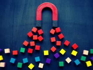 A big magnet attracting square blocks.